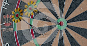 4K - Darts game. Close-up. Throwing darts at a dartboard.