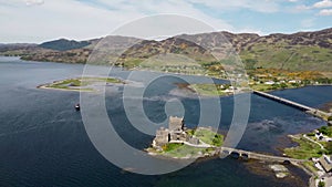 4k drone footage of the ancient Eilean Donan Castle overlooking Loch Duich in the Scottish Highlands