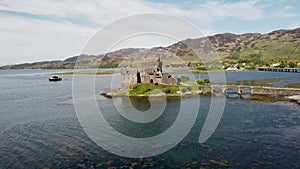 4k drone footage of the ancient Eilean Donan Castle overlooking Loch Duich in the Scottish Highlands