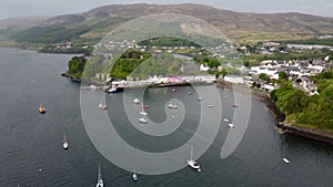 4k drone footage of the colourful houses of Portree Harbour on the Isle of Skye, Scottish Highlands