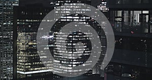 4K Exterior establishing shot of a modern office building at night.