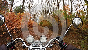 4K. Fantastic motorcycle ride on the road in orange autumn forest, wide point of view of rider. Classic chopper forever!