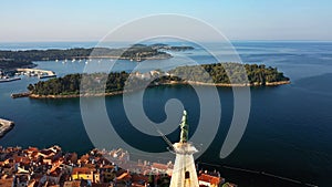 4K. Flight over beautiful Rovinj at sunrise. Morning aerial panoramic view of the old town of Rovinj and church of St. Euphemia.