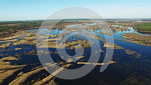4K. Flight over flooded blue river in early spring, aerial panoramic view