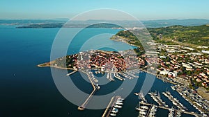 4K. Flight over old town Izola in Slovenia, aerial panoramic view with marina at sunset. Adriatic sea coast. Peninsula of Istria