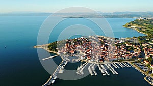 4K. Flight over old town Izola in Slovenia, aerial panoramic view with marina at sunset. Adriatic sea coast. Peninsula of Istria