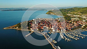 4K. Flight over old town Izola in Slovenia, aerial panoramic view with marina at sunset. Adriatic sea coast. Peninsula of Istria