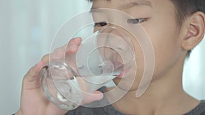 4k follow a glass of water to Asian boy drinking