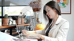 4K footage, busy business woman working with laptop computer and thinking with serious face in coffee shop cafe in the city