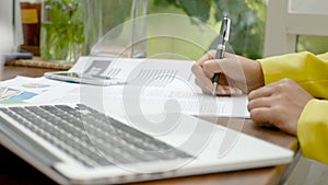 4K footage. close up of businesswoman signing a contract for business agreement with pen at office desk