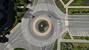 4k footage of a drone hovering over a ring road with cars passing through it