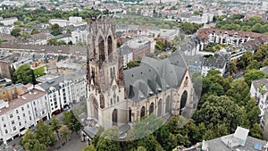 4k footage of a drone panning out to reveal the surrounding area around the Great Saint Martin Church in Cologne, Germany.