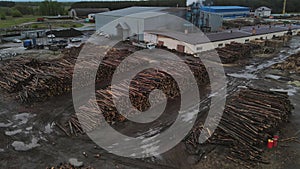 4k footage from a drone rotating over a sawmill filled with tree trunks