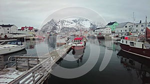 4k footage in the fis with fishing boats at the polar circle herman village in Lofoten , Henningsvaer