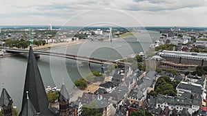 4k footage flying over the historical Great Saint Martin Church towards the Deutz Suspension Bridge in Cologne, Germany.