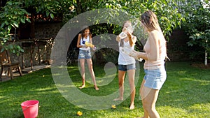 4k footage of happy active family playing with waater guns on grass at backyard