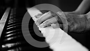 4K footage of piano music pianist hands playing monochrome black and white color. musical instrument grand piano selective focus