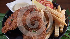 4k footage of a plate of delicious fish and chips rotating close up