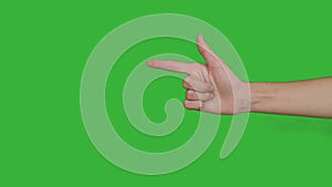 4K footage real time close-up hand of asian young girl gesturing fire gun weapon with fingers isolated on chroma key green screen