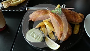 4k footage side panning, Family and friends enjoy eating fish and chips in a traditional English cafe. chips with french fries