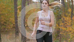 4K footage of tired woman taking short break while jogging at forest