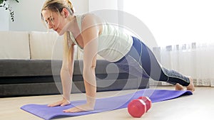 4k footage of young woman falling on floor after doing planking and pushups at home