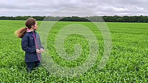 4k Girl alone in a wheat field searching for somebody.