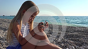 4K Girl Portrait Playing Tablet on Beach, Child Using Smart Phone Coastline View