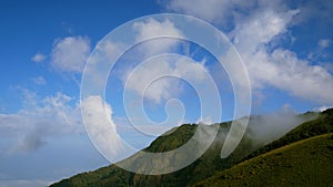 4K. great view of foggy mountains at national park in the mist with blue sky and white cloud running with speed up.