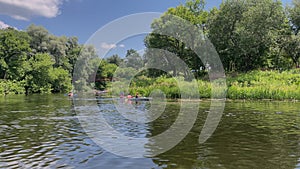 4k Group of people in kayak are swimming on river. Descent along river.