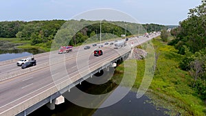 4K Highway traffic across a bridge, aerial shot