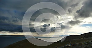 4k huge dark clouds mass rolling over lake namtso & mountain,tibet mansarovar.