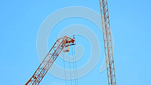 4K large construction site with several busy cranes at dusk with clear blue sky