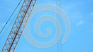 4K large construction site with several busy cranes at dusk with clear blue sky