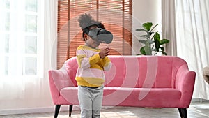 4K Little african girl learning dancing using virtual reality headset