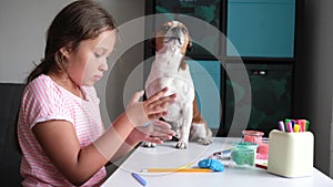 4k. little cute caucasian girl and chihuhua dog sculpt together at home