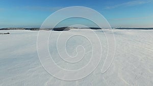 4K. Low flight above snow fields in winter, aerial view (Snow desert)