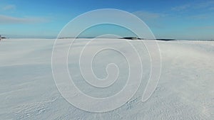 4K. Low flight and takeoff above snow fields in winter, aerial view (Snow desert)