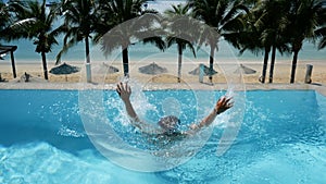 4K. man drowning in water at swimming pool. man drowning in the pool try to survive by put hand up asking for help