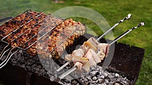 4K. Medium shot. Grilled chicken fillet in a grid. Cooking bacon on the grill. Recreation. Tasty food on the grill. B-B-Q. Brazier