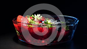 4k. Men hands cuting juicy watermelon on kitchen background Mix of wild forest berries on black background, collection of strawber