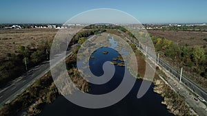 4k movie. Aerial fly over Dambovita river nearby Bucharest city in a beautiful morning in autumn season.