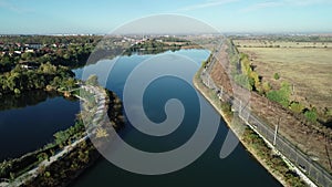 4k movie. Aerial fly over Dambovita river nearby Bucharest city in a beautiful morning in autumn season.