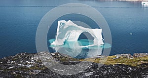 4k moving Timelapse Video clip of Iceberg with arch in blue ocean melting. Near Ilulissat, Greenland in Rodebay Oqaatsut