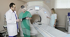 4K Nurse presses settings button of CT MRI scanner.
