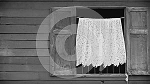 4K. open window with white curtain moving by the wind. window frame with wooden wall at old house, black and white color