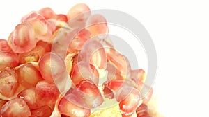 4K Organic healthy red fruit close-up. Open pomegranate fruit rotates on a white  background. Pomegranate seeds.