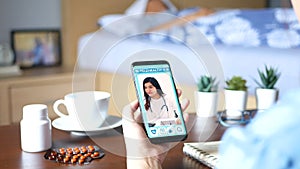 4K. Patient`s relatives use video conference, make online consultation with doctor on mobile application, ask doctor about illness