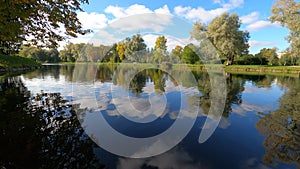 4k peaceful timelapse of reflection of trees in the pond in Moskovsky Victory Park, Saint Petersburg, Russia.