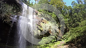 4K People practice rappelling, passing through waterfall canyon and riverbed